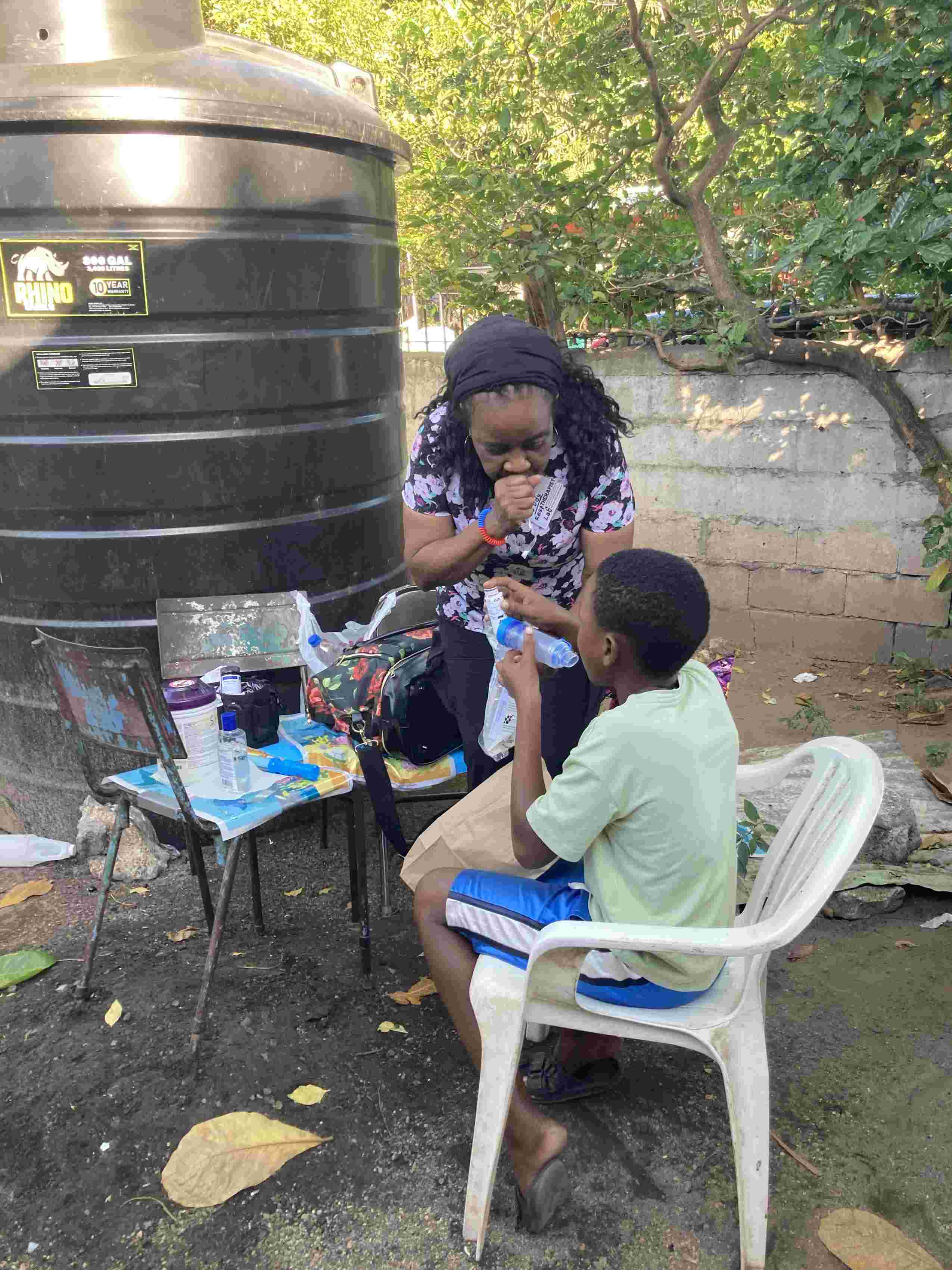 Judy helping a child with a spacer